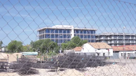 Fence separates viewer from active construction zone Stock Footage 336558657