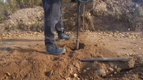 Fence setup underway, preparing posts in sunny yard, installing fence posts with Stock Footage 319690981