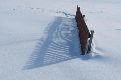 Fence Shadow Pattern on Fresh Snow Stock-Fotos