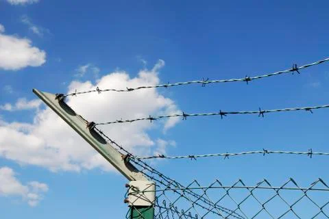 Fence with sharp barbed wire Stock Photos