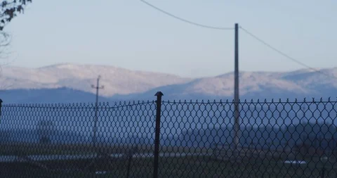 Fence sihouette with mountains in the background Video stock 89951939