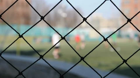 Fence With Soccer Game in Background Stock Footage 7742290