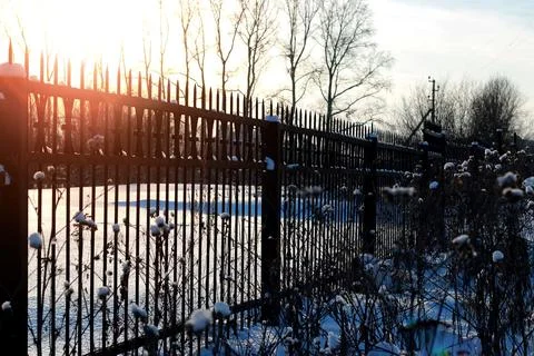 Fence with spikes sun Foto stock