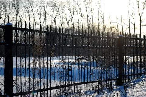 Fence with spikes sun Foto stock