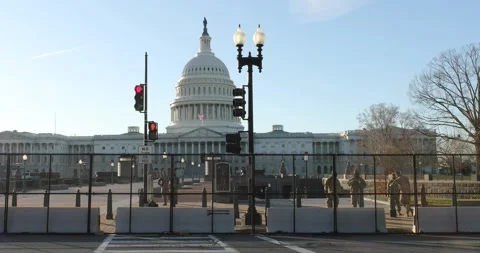 A fence surrounds the U.S. Capitol building after the Jan. 6 riots Stock Footage 146348523