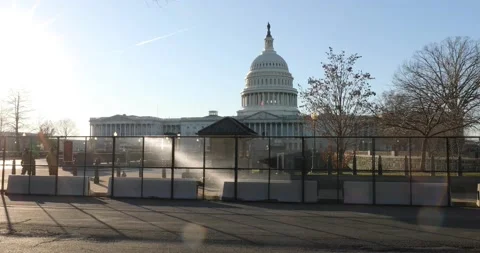 A fence surrounds the U.S. Capitol building after the Jan. 6 riots Stock Footage 146348571