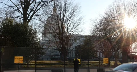 A fence surrounds the U.S. Capitol building after the Jan. 6 riots Stock Footage 146351002