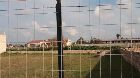 Fence villa beachside sicily italy daytime road street dirt courtyards backyards Stock Footage 252152269