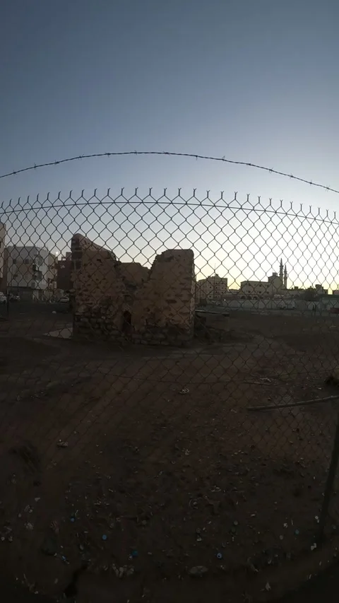 Fenced Ancient Stone Ruins and Distant Mosque Stock Footage 346534472