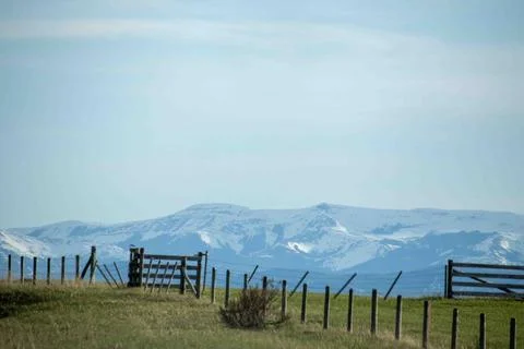 A Fenced In Area With A Mountain In The Background. Stock Photos