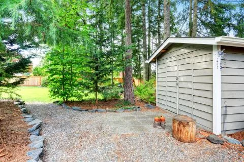Fenced back yard with well kept garden and siding barn shed. Northwest, USA Stock Photos