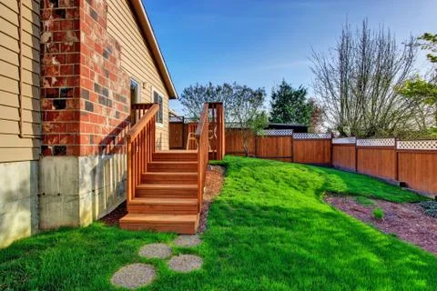 Fenced backyard with walkout deck Stock Photos