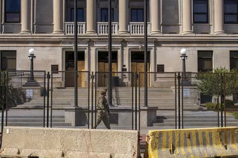 Fenced off building with guard Stock Photos