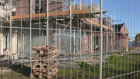 Fenced building site, insulation cavity wall - in scaffolding + pan Stock Footage 221924729