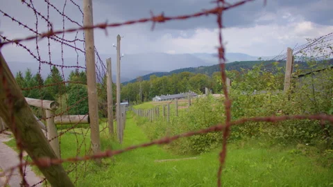 Fenced compound with barracks and fields Stockbeeldmateriaal 299053138