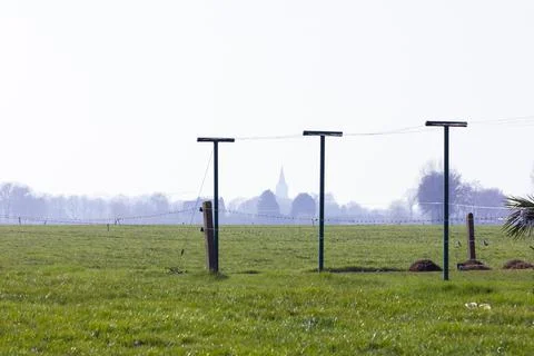 Fenced green land plot on a sunny day Stock Photos