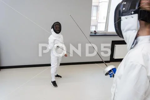 Photograph: Fencer woman with fencing sword. Fencers duel concept ...