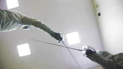 Fencing. bottom-up view. hands and swords. fencers. with fencing safety helmets Stock Footage 154131925