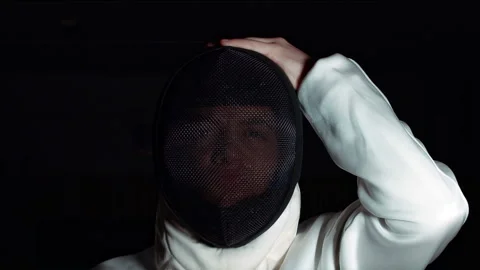 Fencing competitions. Athlete wears a protective mask on his head before the Stock Footage 189248520