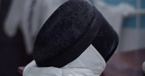 Fencing mask on table in gym Stock Footage 224964814
