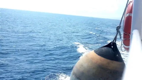 Fender and life buoy on the side of the moving boat Stock Footage 83503524