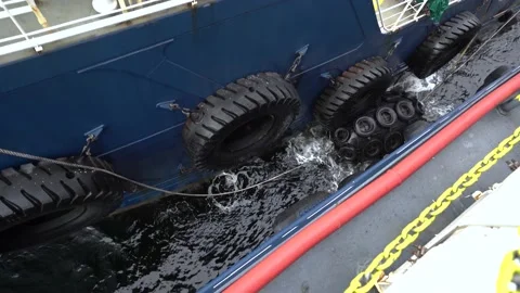 Fender between ships. Two vessels side by side. Black fenders on side of boat Stock Footage 200920295