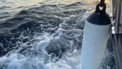 Fender hanging low as the vessel moves through sunset waters Stock Footage 321768346