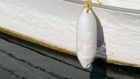 The fender hanging from the side of the boat. Stock Footage 268900025