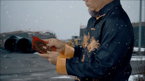 Feng Shui Master checks the Lo-Pan compass and adjusts a city construction Video stock 122724613