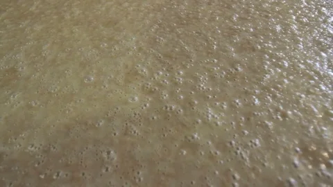 Fermentation bubbles in vat of mash Stock Footage 70112498
