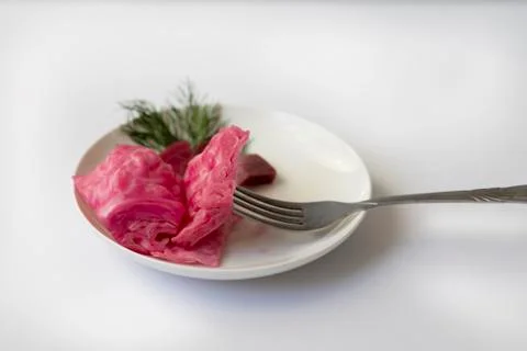 Fermented cabbage, with beets on a plate Stock Photos