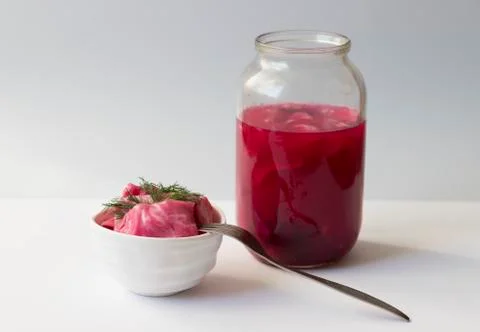 Fermented cabbage, with beets on a plate Stock Photos