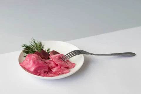 Fermented cabbage, with beets on a plate Stock Photos