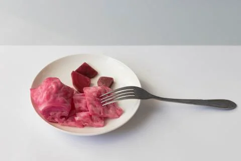 Fermented cabbage, with beets on a plate Stock Photos