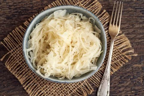 Fermented cabbage in a bowl with a fork Stock Photos
