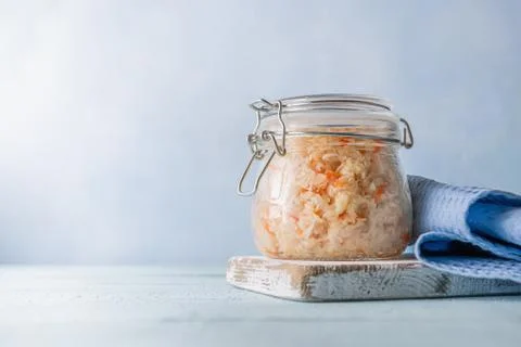 Fermented cabbage with carrot on blue background Stock Photos