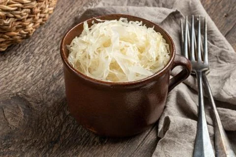 Fermented cabbage in a pot on a table Stock Photos