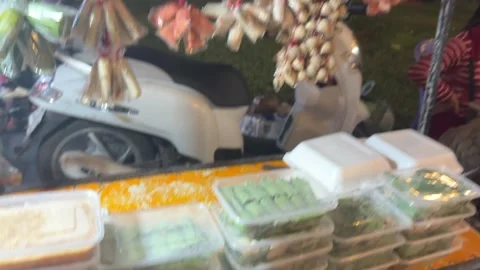 Fermented cured pork and grilled egg street food at night market in Cambodia Stock Footage 336595877