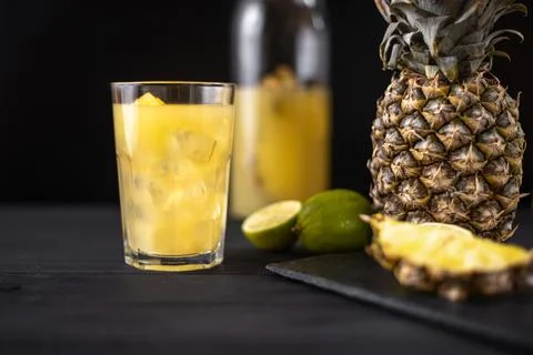 Fermented pineapple lemonade on a black background Stock Photos