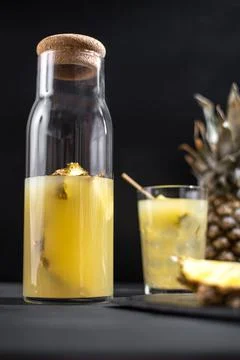 Fermented pineapple lemonade on a black background. Vertical frame Fotos Stock