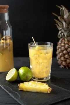 Fermented pineapple lemonade on a black background Photos