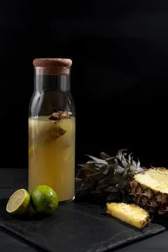 Fermented pineapple lemonade on a black background. Vertical frame Stock Photos