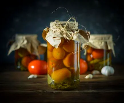 Fermented tomatoes on a dark background. Stock Photos