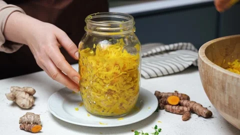 Fermenting Cabbage with Turmeric close-up Stock Footage 305750246