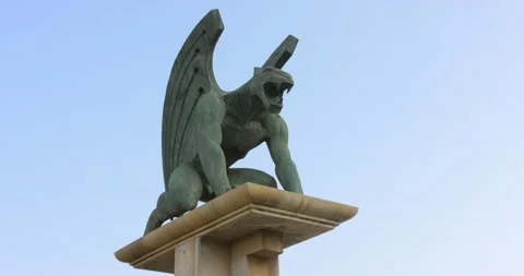 Ferocious large bronze green Gargoyle statue overlooking the landscape Stock Footage 165865087