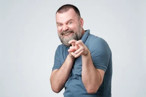 Ferocious may guy pulls his hands and shows his teeth, posing like a tiger. Stock Photos