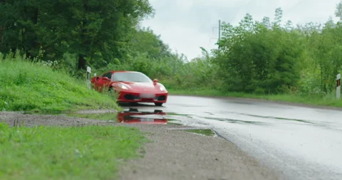 Ferrari speeds through a puddle Stock Footage 146768104