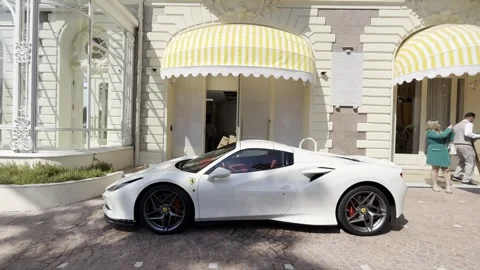 Ferrari supercar under yellow canopy at Carlton Ritz hotel Stock Footage 315408043