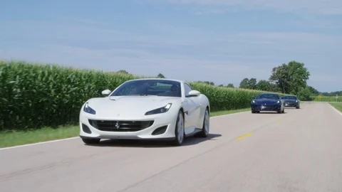 Ferrari's Driving Through Cornfield 4k Stock Footage 103979433