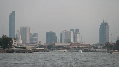 Ferries move below hazy Bangkok skyline Video stock 340308688